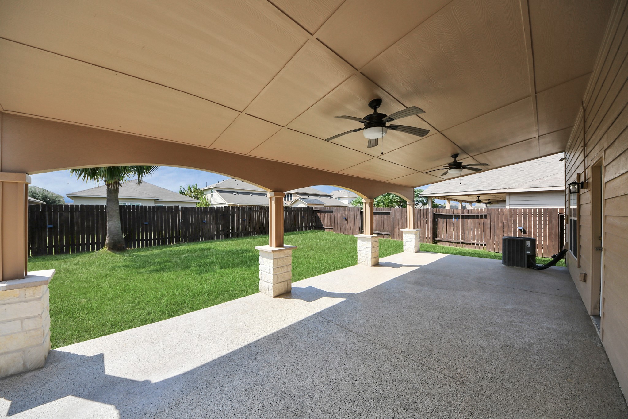 6931 Primrose Road Baytown, TX 77521 - Photo 44 of 50 Expansive covered patio with dual ceiling fans, perfect for outdoor entertaining and relaxation.