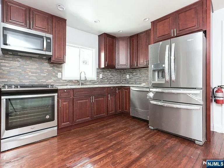 202 Kerrigan Boulevard Newark, NJ 07106 - Photo 1 of 5 a kitchen with stainless steel appliances a stove a sink and a microwave