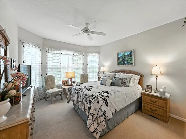 a bedroom with a bed a couch and a window