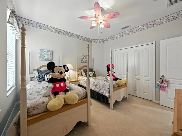 a dining room with furniture a chandelier and wooden floor
