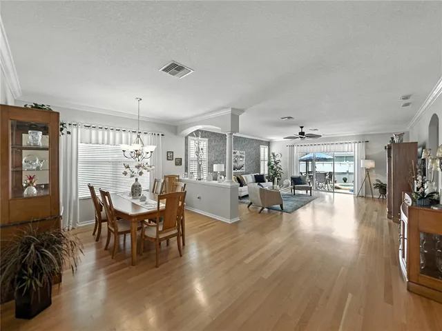 a view of a dining room with furniture and chandelier
