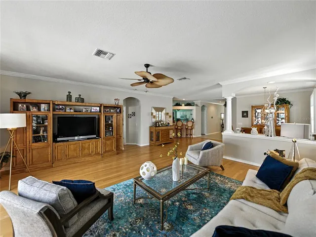 a view of a dining room with furniture wooden floor and chandelier
