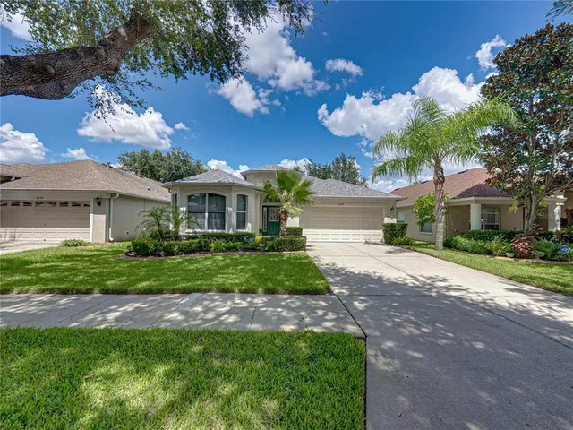 a front view of a house with a garden and a yard