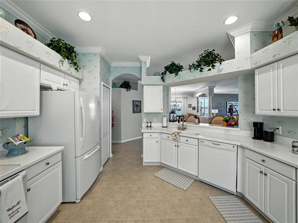 2530 Cross More Street Valrico, FL 33594 - Photo 32 of 61 a kitchen with white cabinets and center island