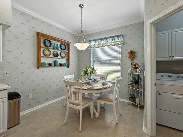a spacious bedroom with a bed and a chandelier