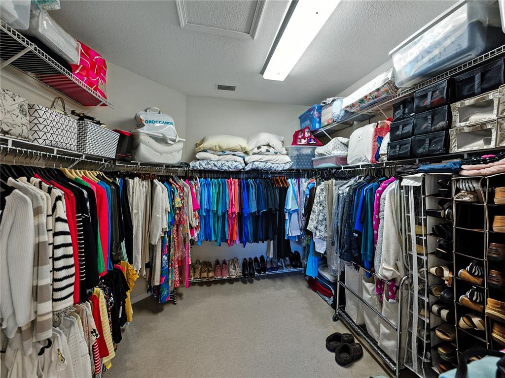 2530 Cross More Street Valrico, FL 33594 - Photo 48 of 61 a view of walk in closet with clothes and shoes