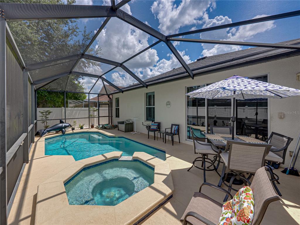 2530 Cross More Street Valrico, FL 33594 - Photo 53 of 61 a view of a backyard with a patio and outdoor seating