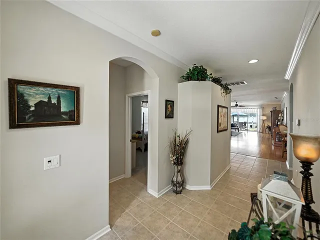 a large bedroom with a bed and a flat screen tv