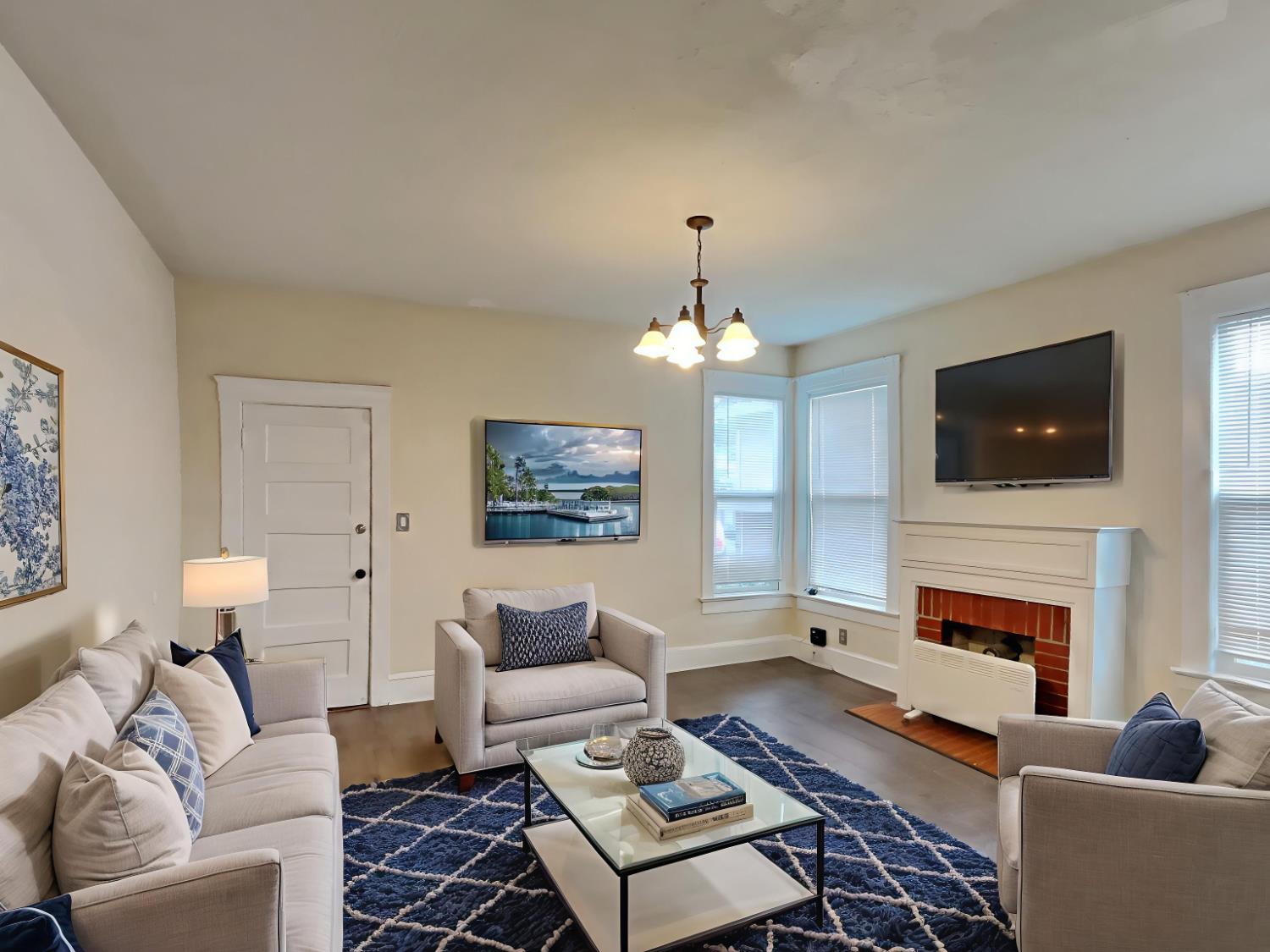 a living room with furniture a fireplace and a flat screen tv