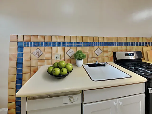 a bathroom with a sink and white cabinets