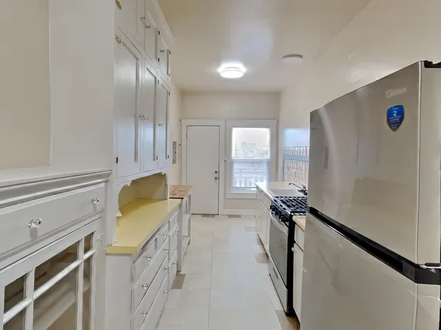 a view of a kitchen with a sink and cabinets