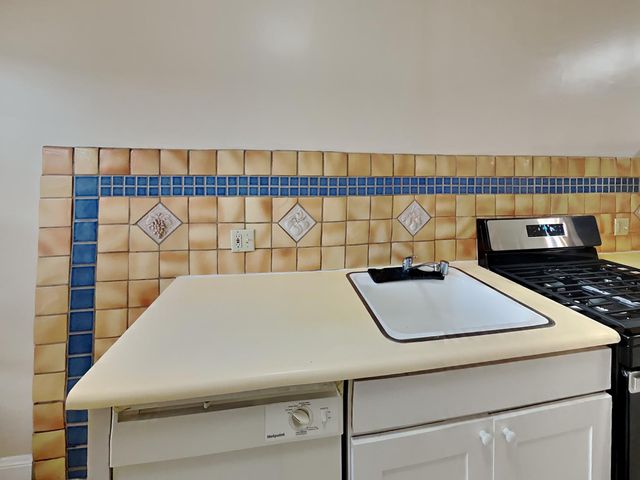 a close up of a sink a table and a rug