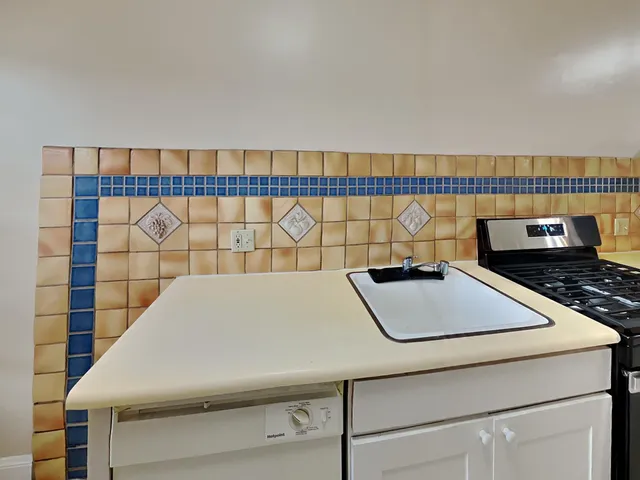 a close up of a sink a table and a rug