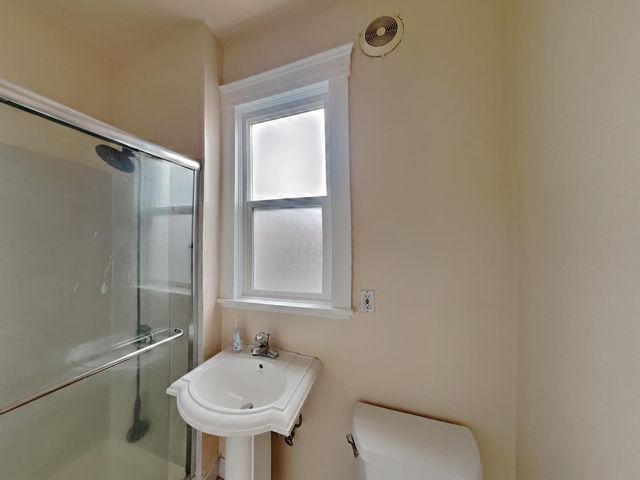 a bathroom with a sink toilet and mirror