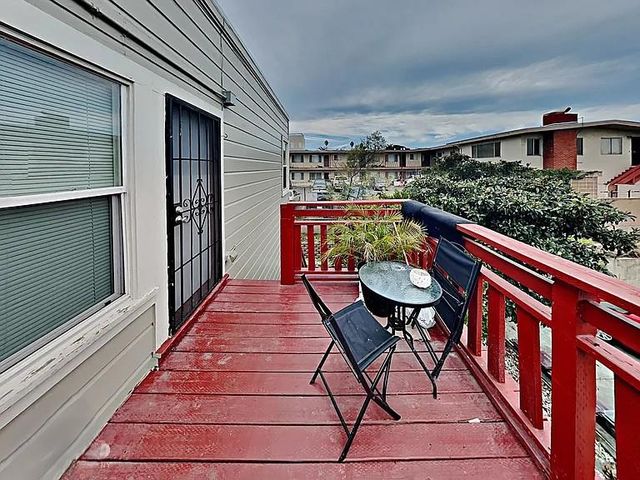 a balcony view with a seating space