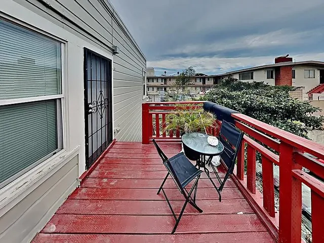 a balcony view with a seating space