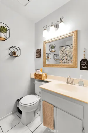 a bathroom with a toilet a sink and a mirror
