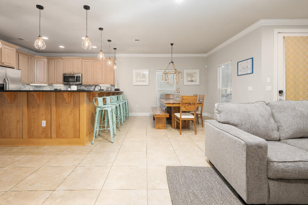 202 Kono Way Destin, FL 32541 - Photo 4 of 29 a living room with furniture a counter space and a view of kitchen