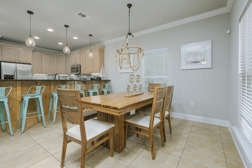 202 Kono Way Destin, FL 32541 - Photo 6 of 29 a dining area with a table chairs and a kitchen view
