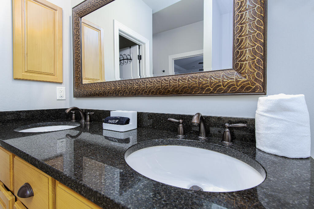 202 Kono Way Destin, FL 32541 - Photo 10 of 29 a bathroom with a granite countertop sink and a mirror