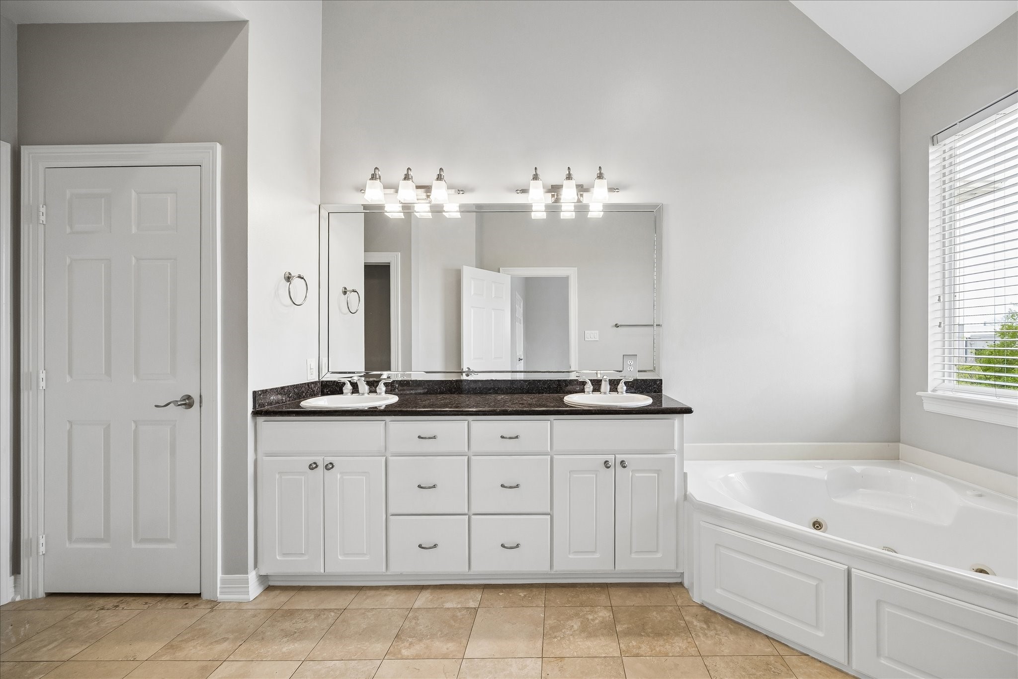 2423 Ralph Street Houston, TX 77006 - Photo 16 of 24 a bathroom with a granite countertop sink a mirror a and a bathtub