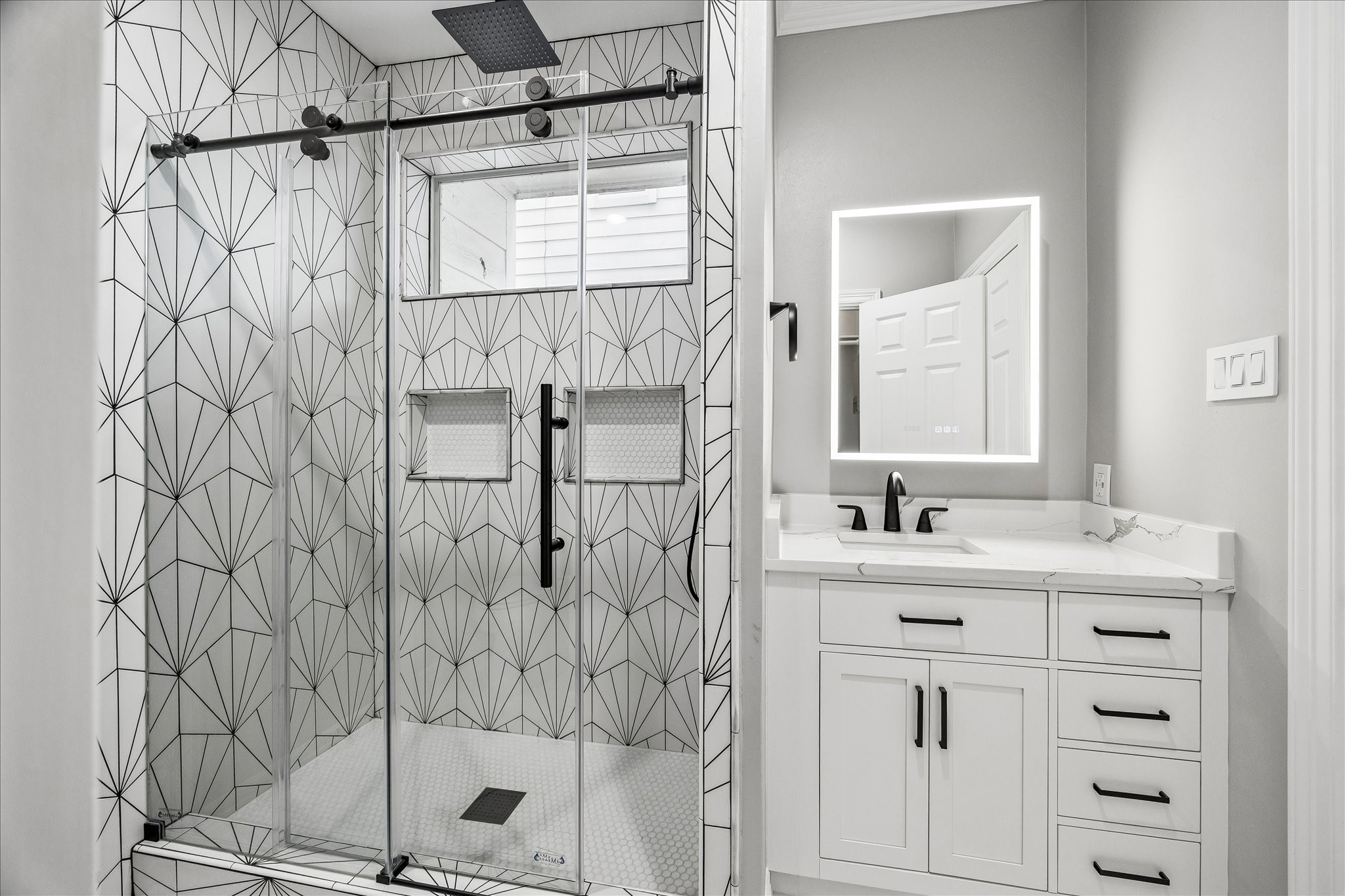 2423 Ralph Street Houston, TX 77006 - Photo 2 of 24 a bathroom with a shower sink vanity and mirror