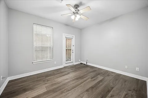 wooden floor in an empty room with a window