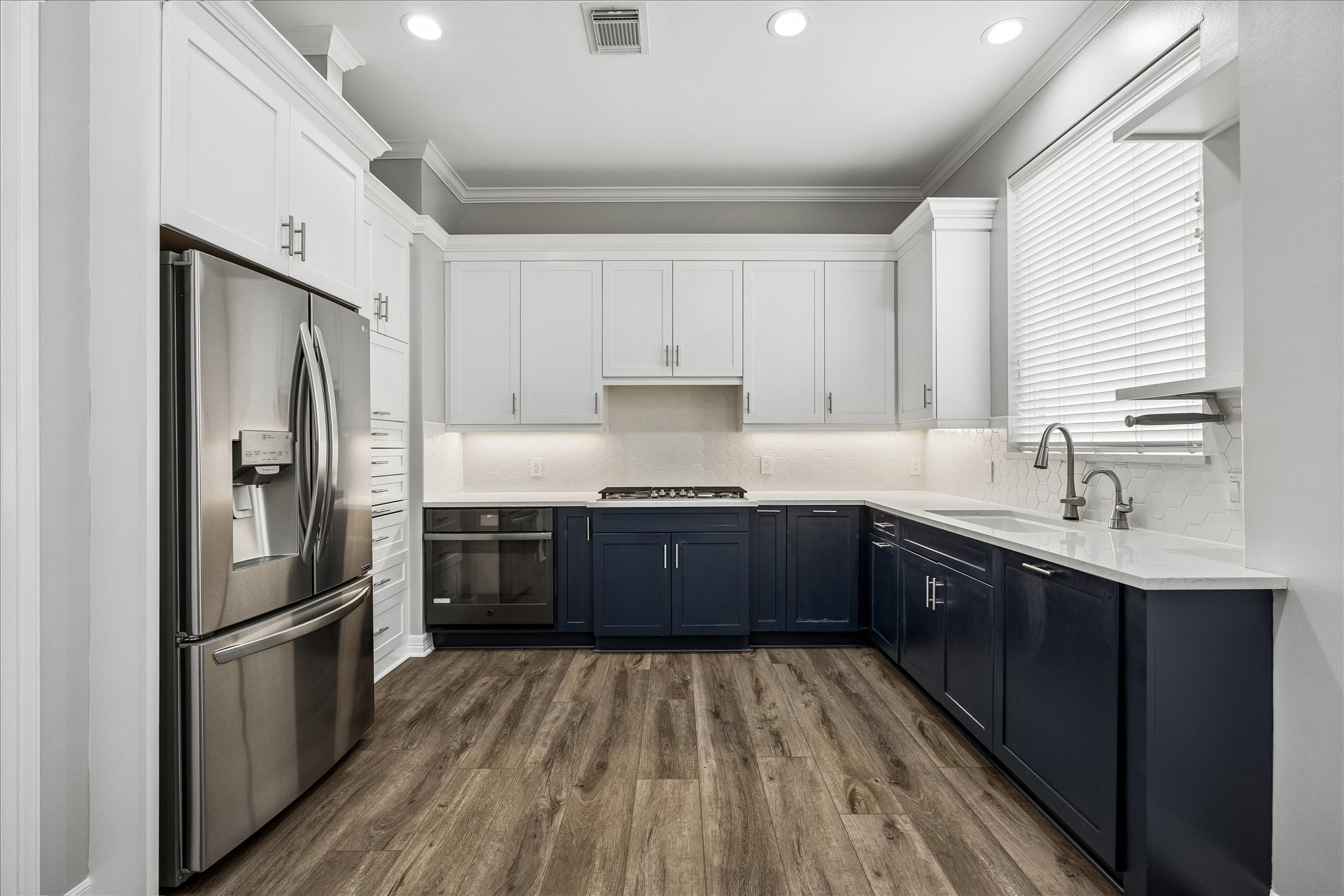 2423 Ralph Street Houston, TX 77006 - Photo 4 of 24 a kitchen with a refrigerator a sink and dishwasher with wooden floor