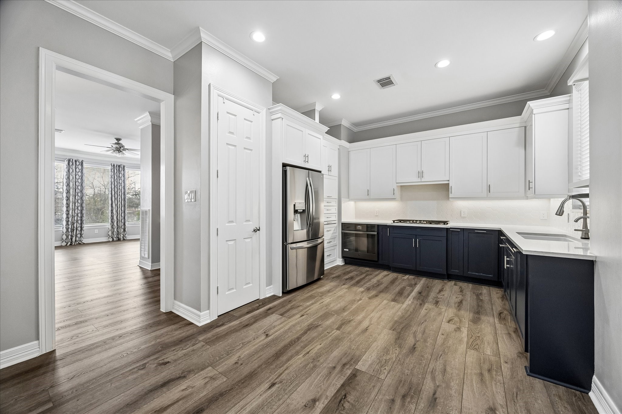 2423 Ralph Street Houston, TX 77006 - Photo 6 of 24 a kitchen with stainless steel appliances a sink cabinets and wooden floor