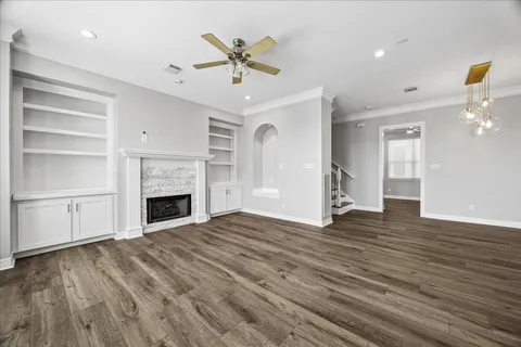 a view of empty room with wooden floor and fireplace
