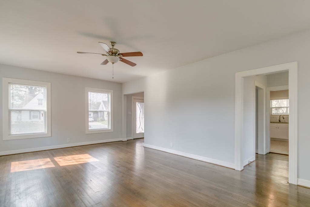 3321 Charleston Street Houston, TX 77021 - Photo 15 of 32 an empty room with wooden floor chandelier fan and windows