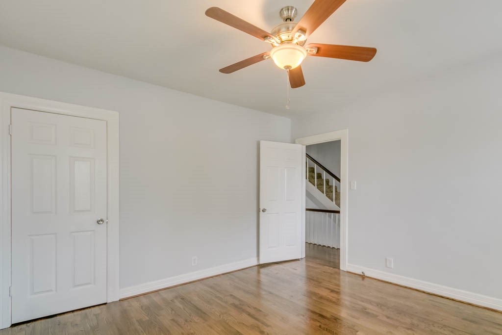 3321 Charleston Street Houston, TX 77021 - Photo 20 of 32 an empty room with wooden floor a ceiling fan and closet