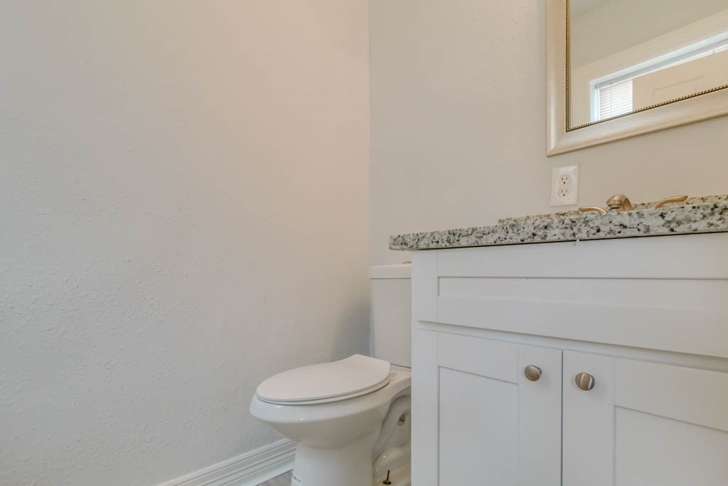 3321 Charleston Street Houston, TX 77021 - Photo 7 of 32 a bathroom with a granite countertop toilet and a sink
