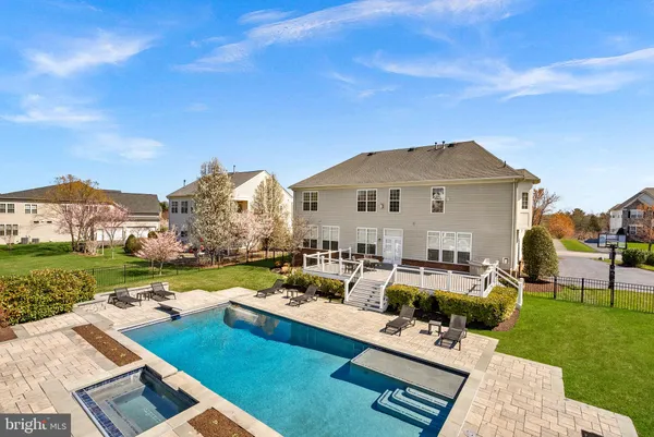 a view of a house with couches chairs and a big yard