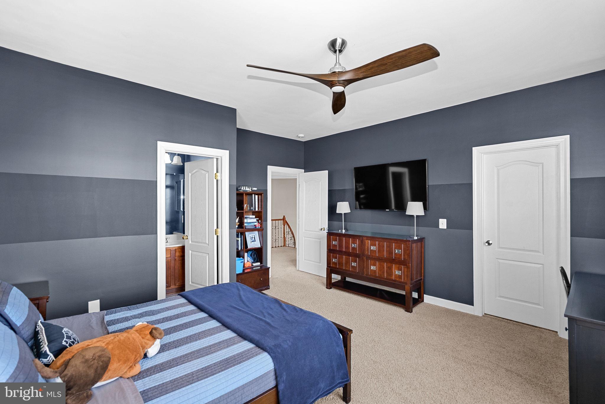 22461 Terra Rosa Place Ashburn, VA 20148 - Photo 28 of 67 a bedroom with a bed and a flat screen tv