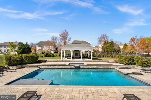 a swimming pool with outdoor seating and yard