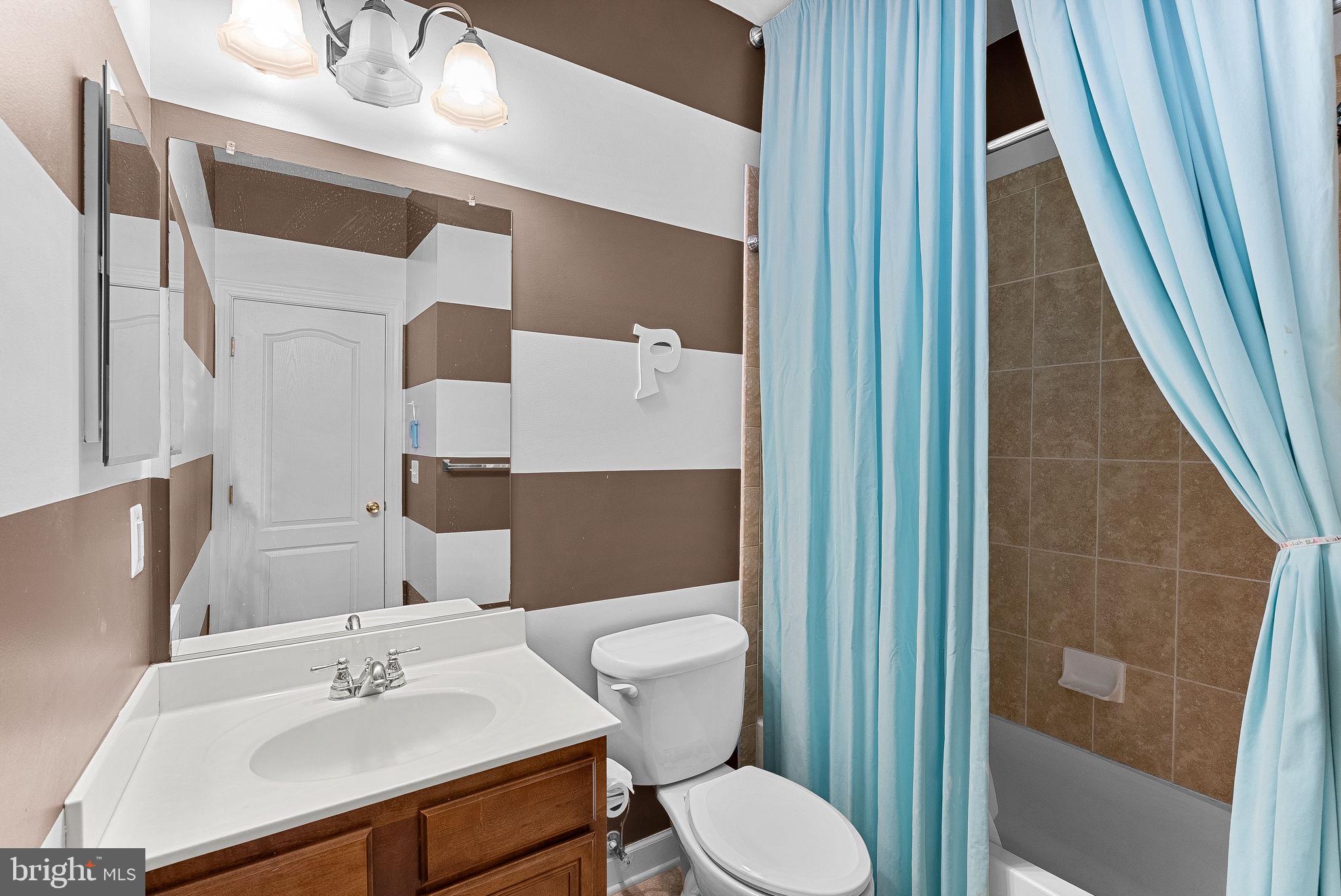 22461 Terra Rosa Place Ashburn, VA 20148 - Photo 31 of 67 a bathroom with a sink a toilet and shower