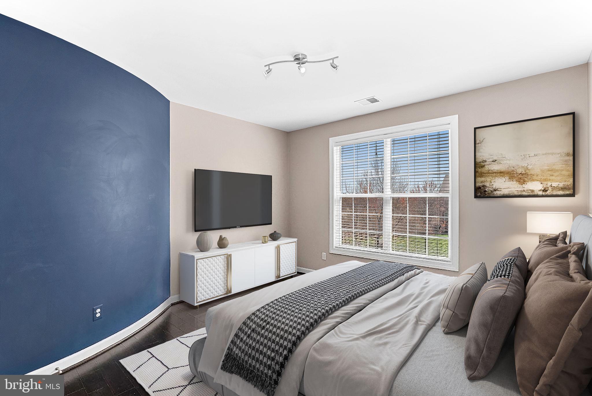 22461 Terra Rosa Place Ashburn, VA 20148 - Photo 32 of 67 a bedroom with a bed and a flat screen tv