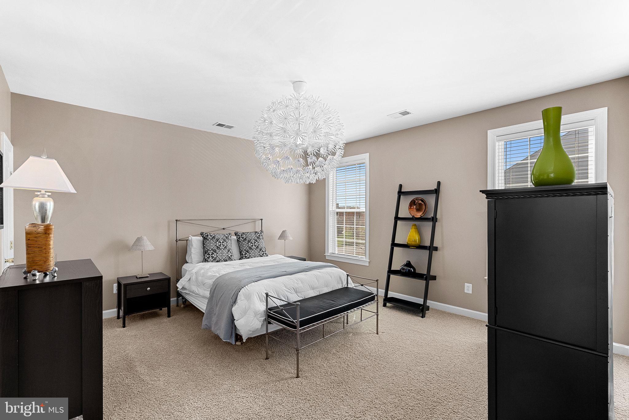 22461 Terra Rosa Place Ashburn, VA 20148 - Photo 35 of 67 a bedroom with a bed and a chandelier