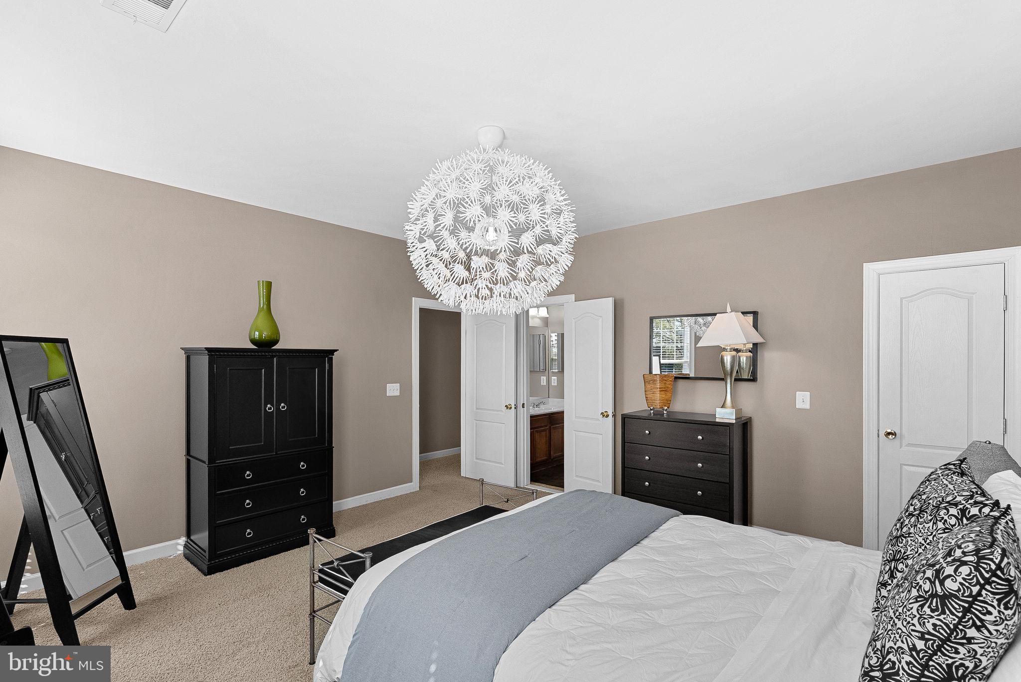 22461 Terra Rosa Place Ashburn, VA 20148 - Photo 36 of 67 a bedroom with a bed and a dresser