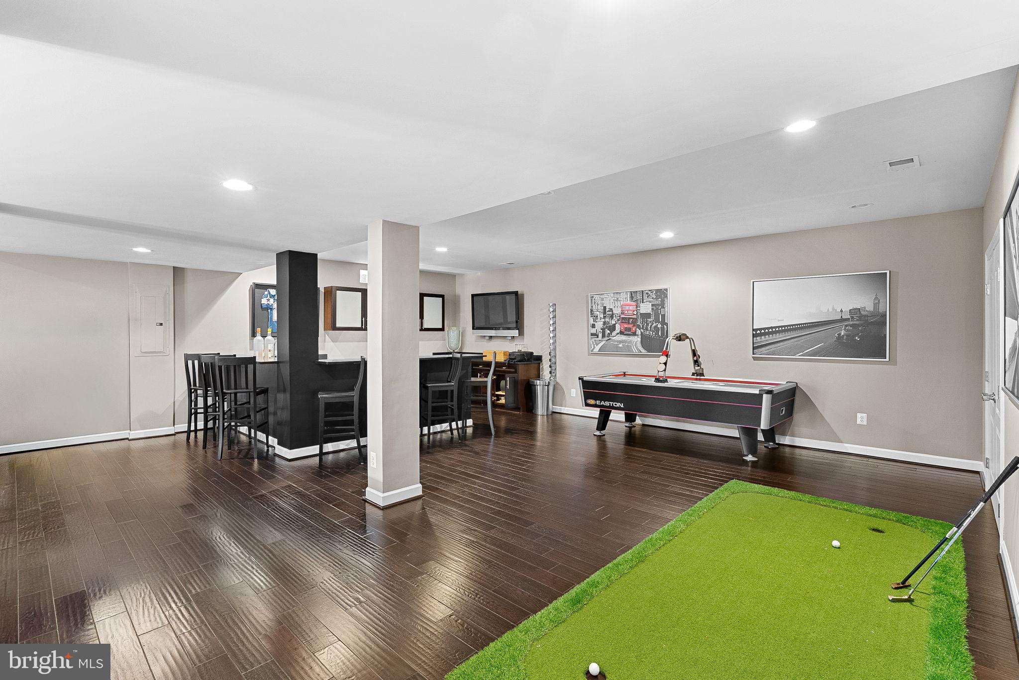 22461 Terra Rosa Place Ashburn, VA 20148 - Photo 46 of 67 a living room with furniture pool table and a dining table with wooden floor
