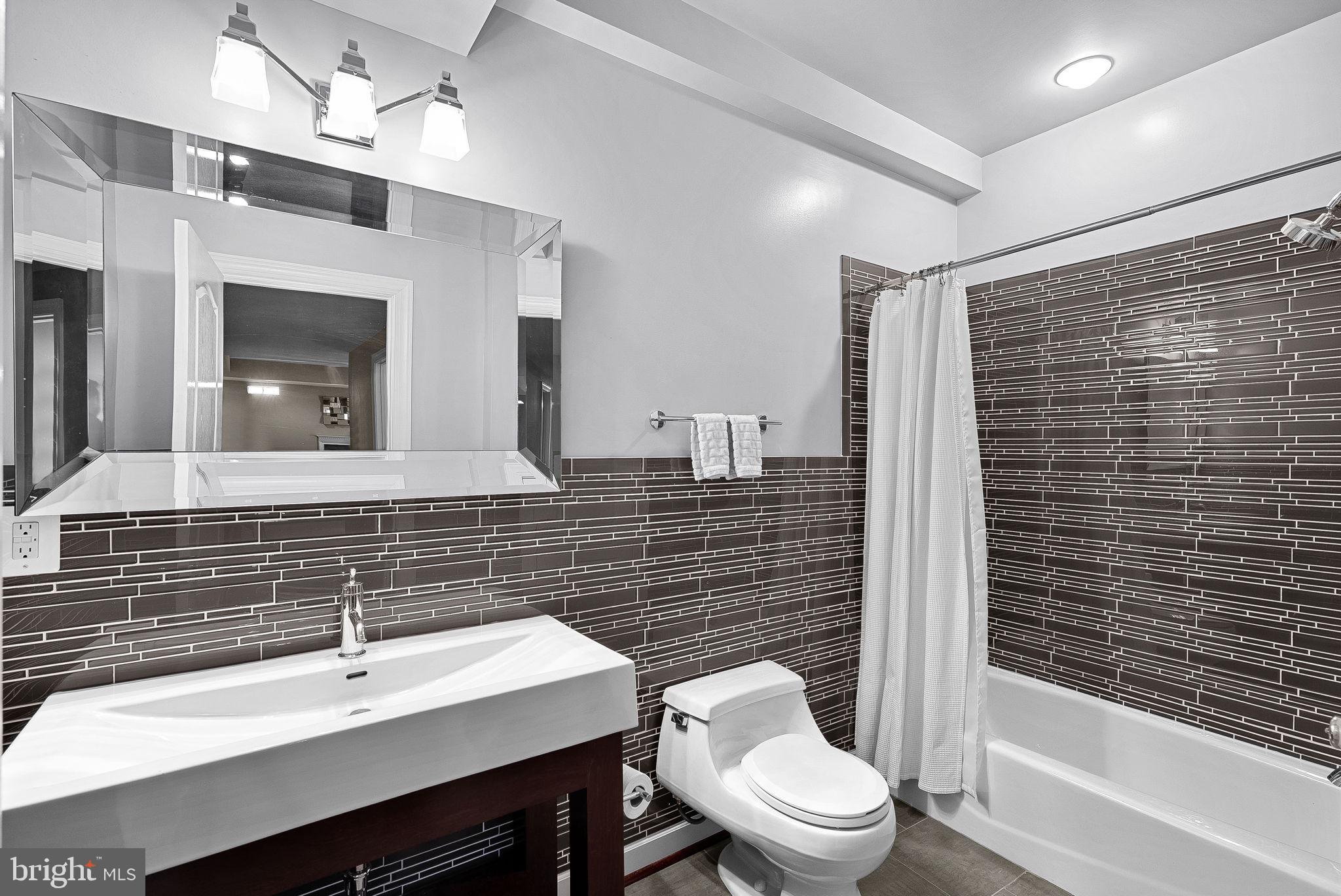 22461 Terra Rosa Place Ashburn, VA 20148 - Photo 49 of 67 a bathroom with a sink a toilet and shower