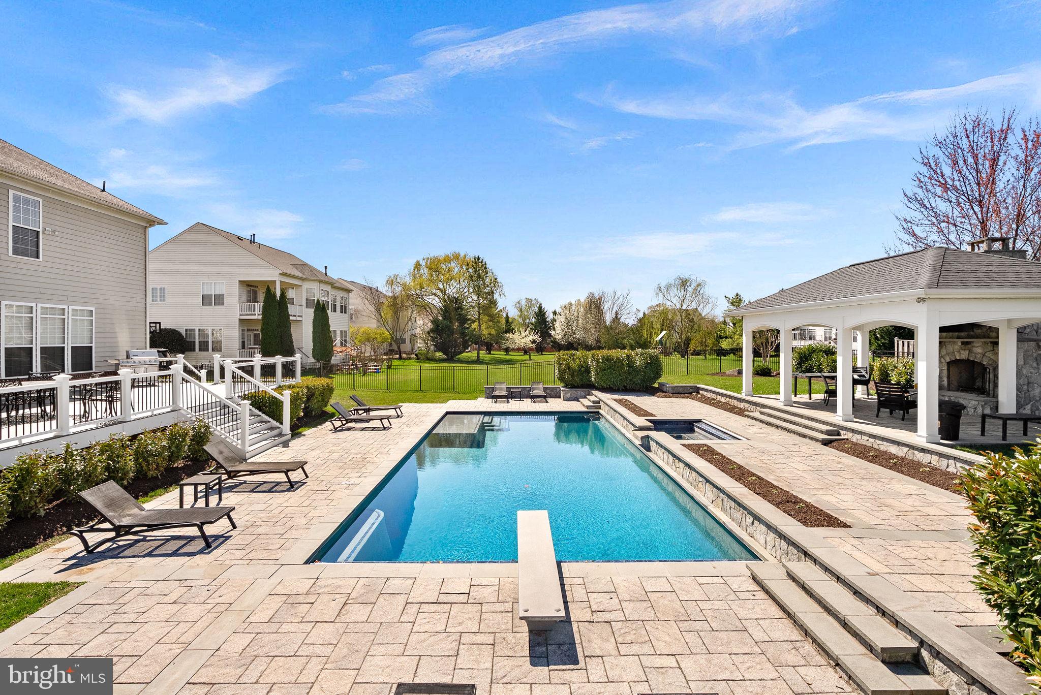 22461 Terra Rosa Place Ashburn, VA 20148 - Photo 57 of 67 a view of a swimming pool with lounge chair
