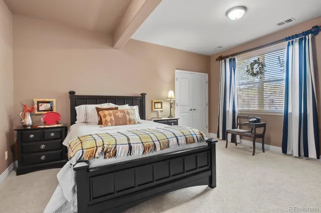 a bedroom with a bed and window