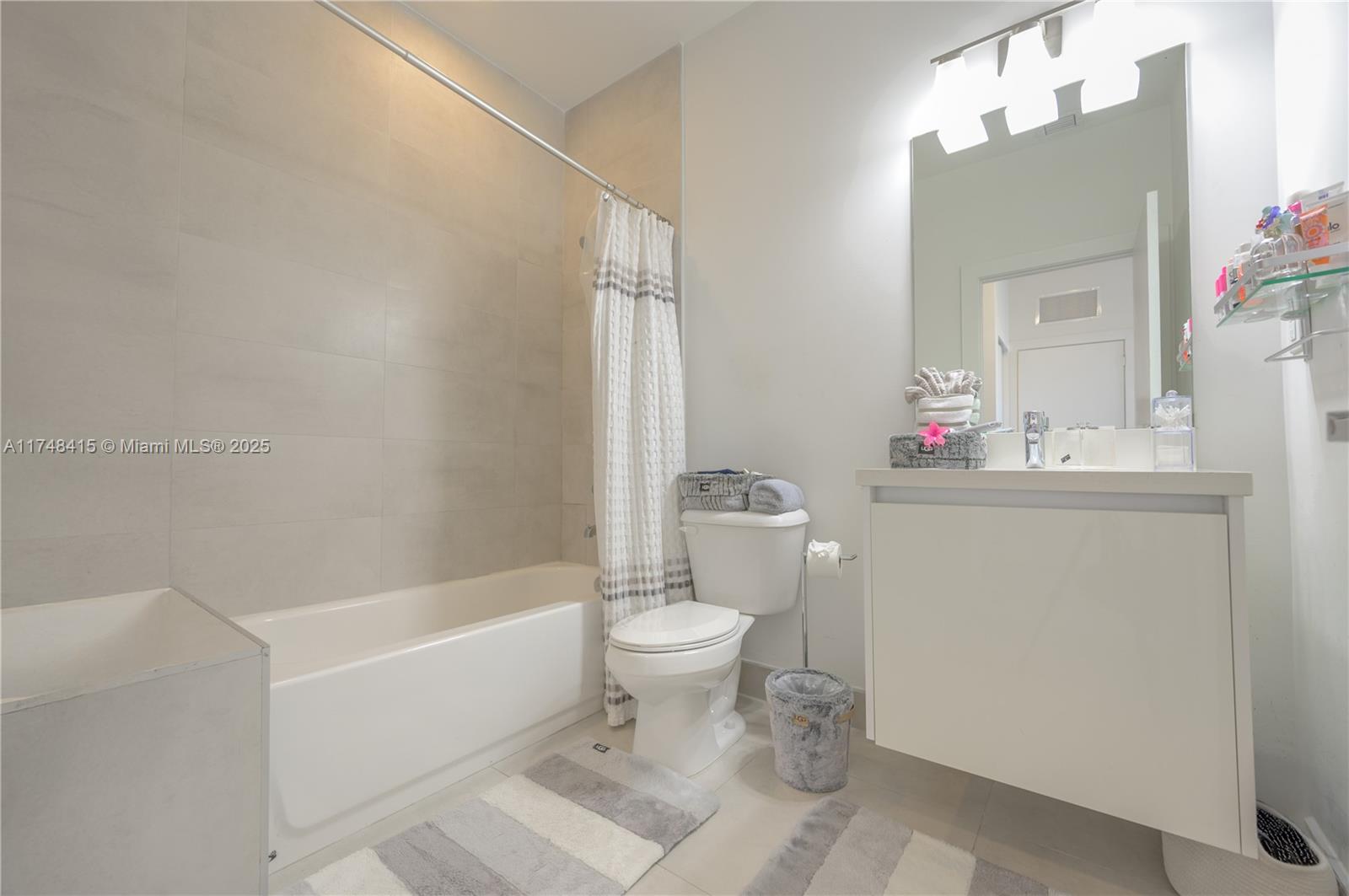 7250 Northwest 103rd Path Doral, FL 33178 - Photo 22 of 28 a white toilet sitting next to a bathroom sink and vanity