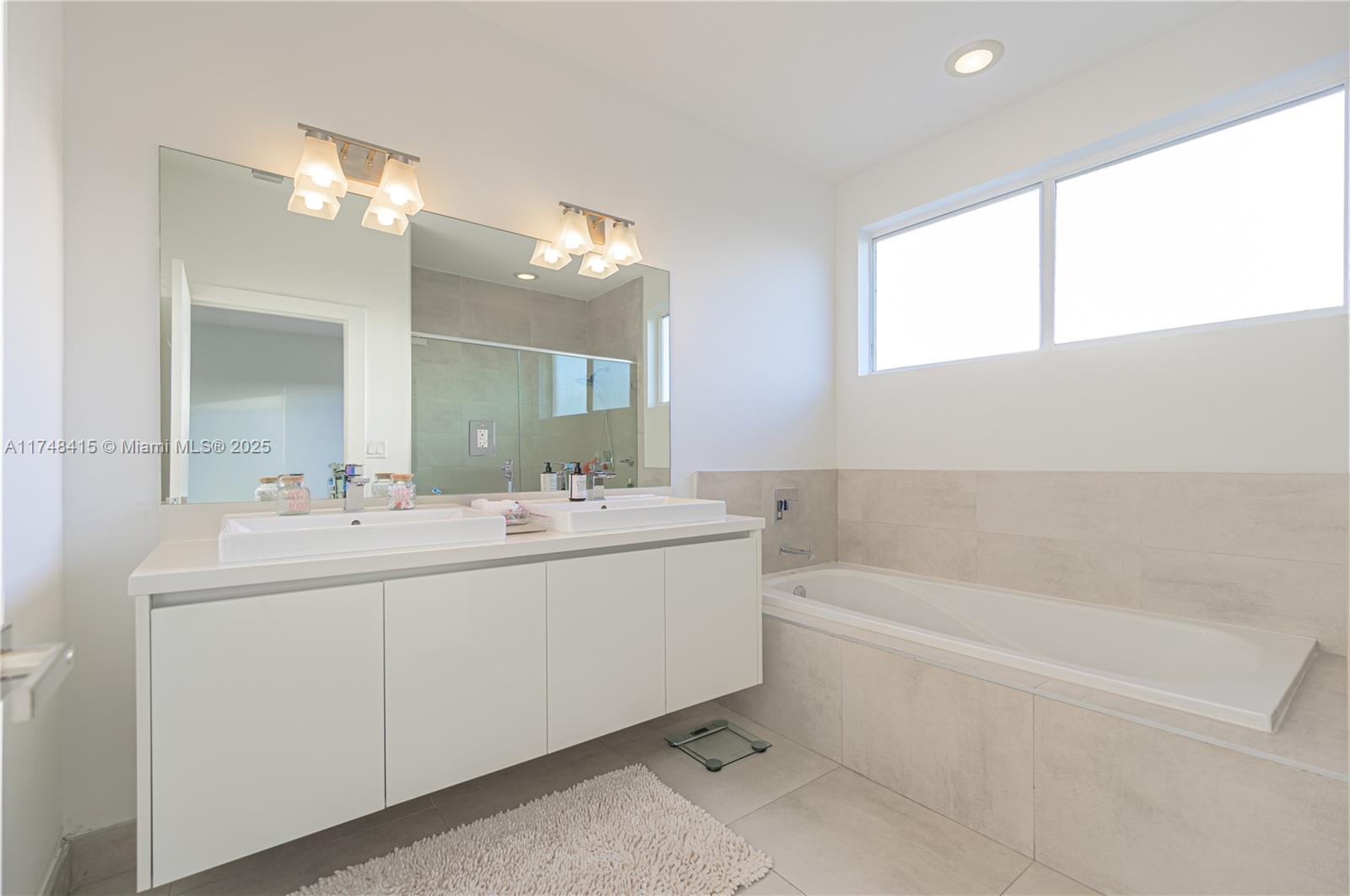 7250 Northwest 103rd Path Doral, FL 33178 - Photo 23 of 28 a bathroom with a tub sink and mirror