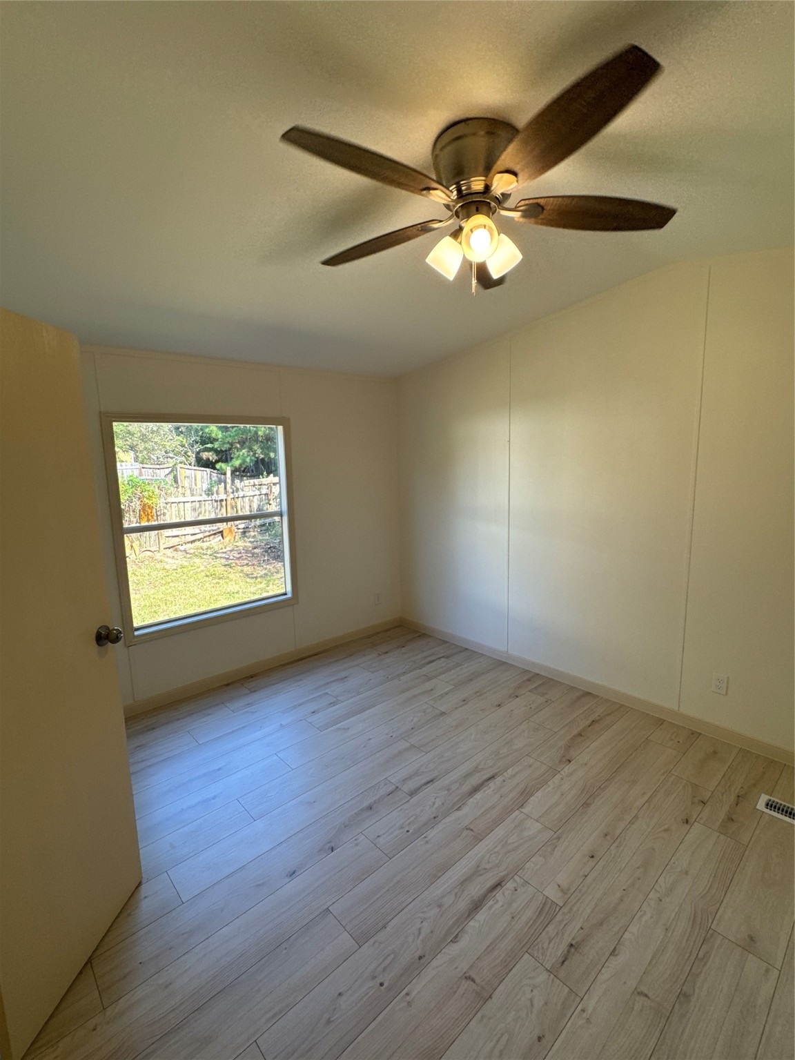 31306 East Timberloch Trail Magnolia, TX 77355 - Photo 11 of 18 an empty room with wooden floor fan and windows