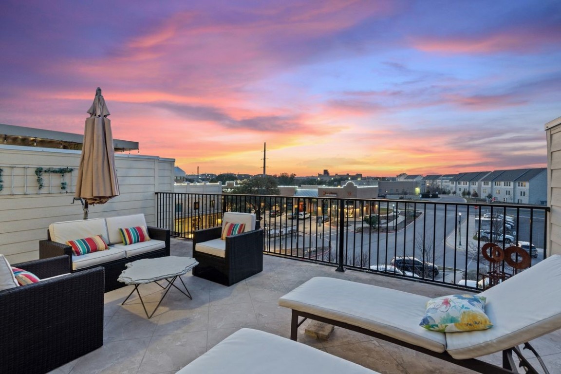 a roof deck with couches and city view
