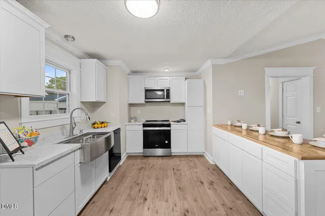 a kitchen with stainless steel appliances a stove sink and cabinets