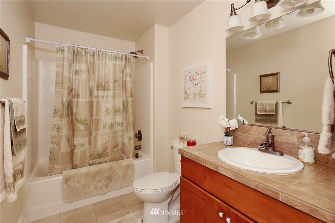 1468 East Smith Road Bellingham, WA 98226 - Photo 14 of 40 a bathroom with a granite countertop sink toilet and shower